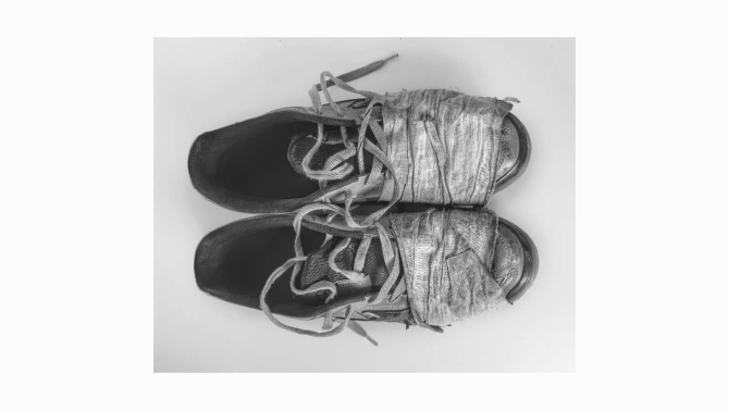 A worn pair of shoes placed side by side