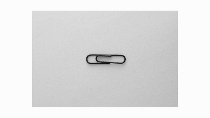 A silver paperclip in a simple outline