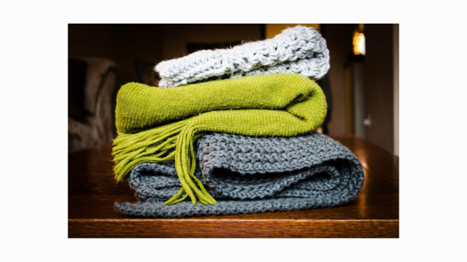 A long scarf draped in a soft curve