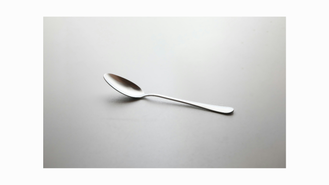 A spoon with a long handle and oval bowl