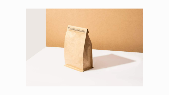 A small upright paper bag with folded top edges
