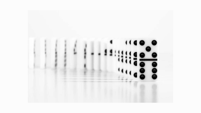 A standing domino tile with a few dots
